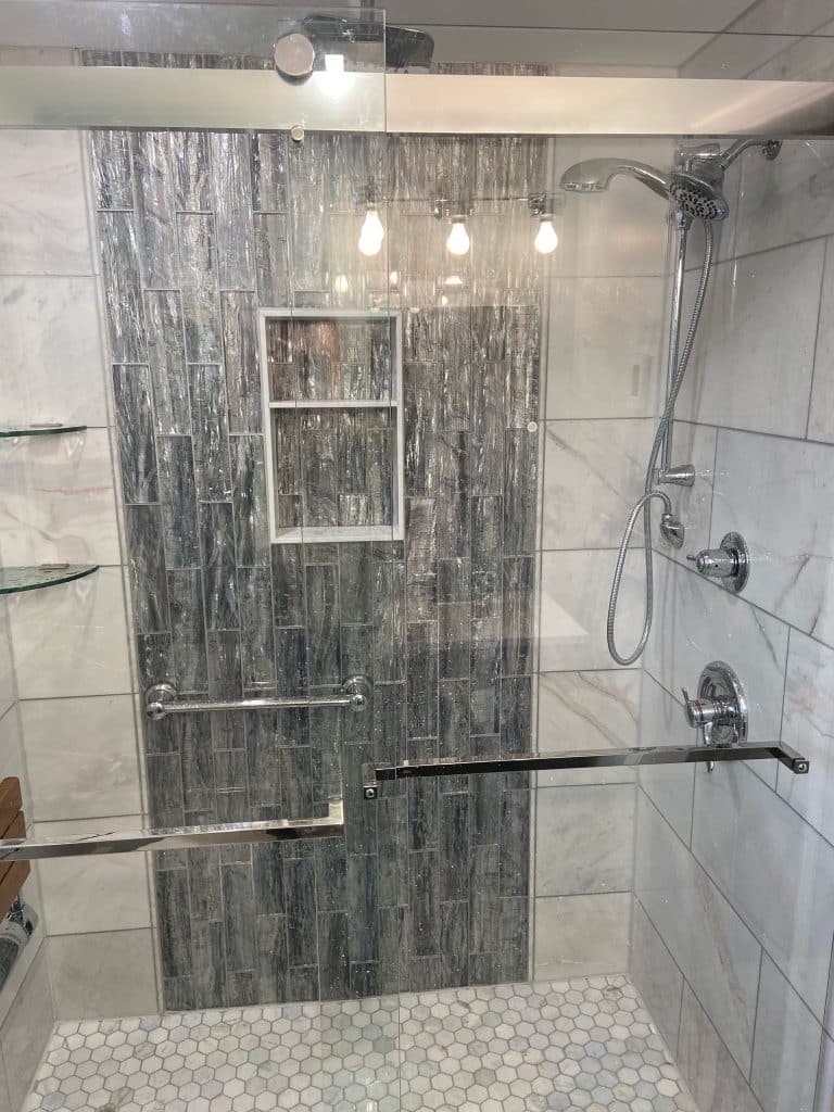 Warrington upscale bathroom renovation by J. Tretter and Sons with designer lighting and marble finishes.